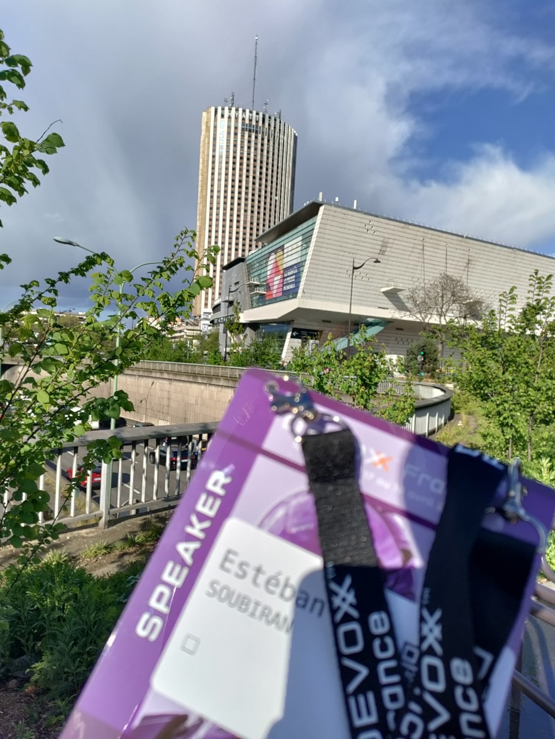 Photo of the exhibition hall and my speaker badge.