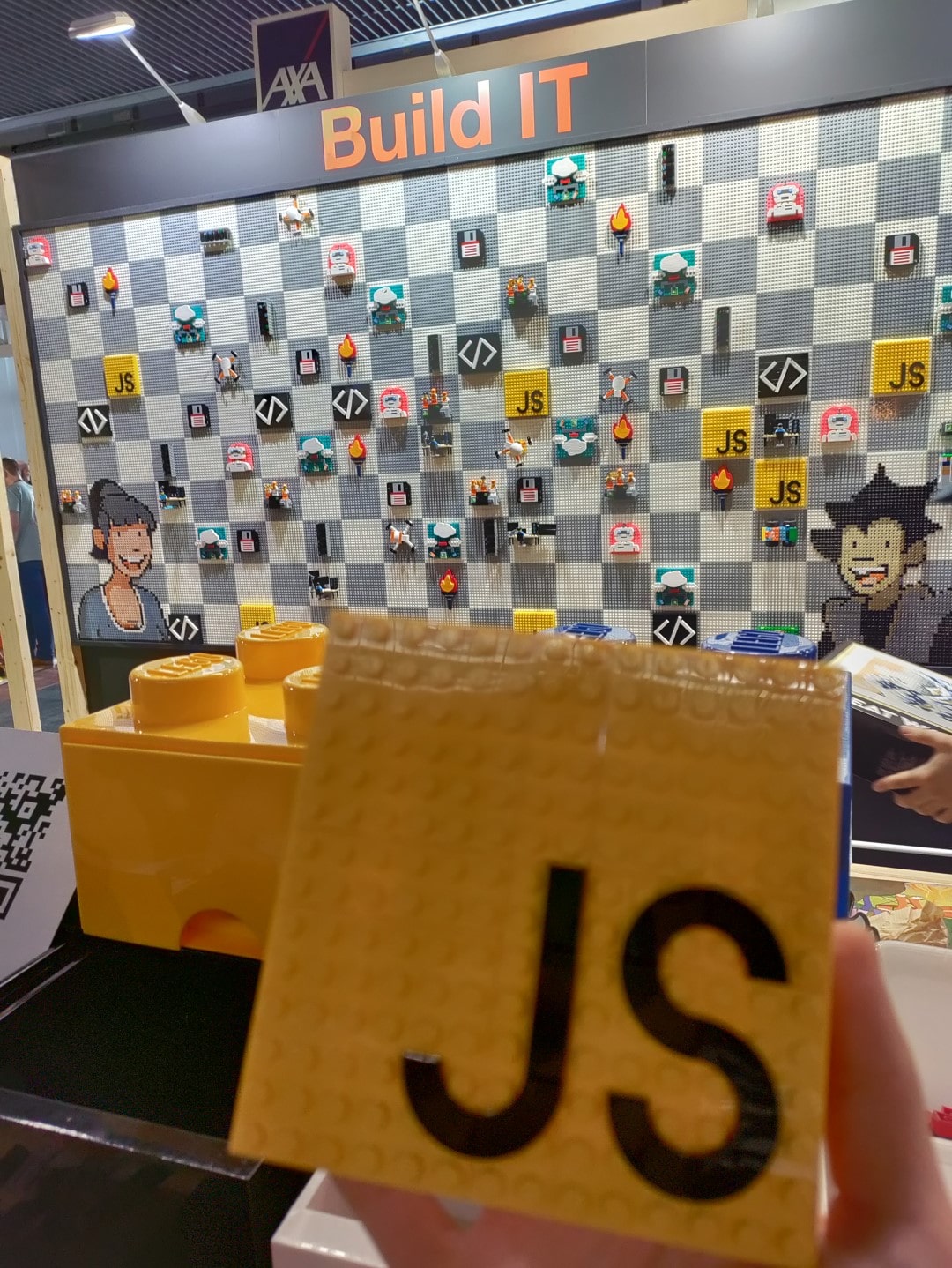 Photo of the JavaScript logo built with LEGO on one of the partner stands.