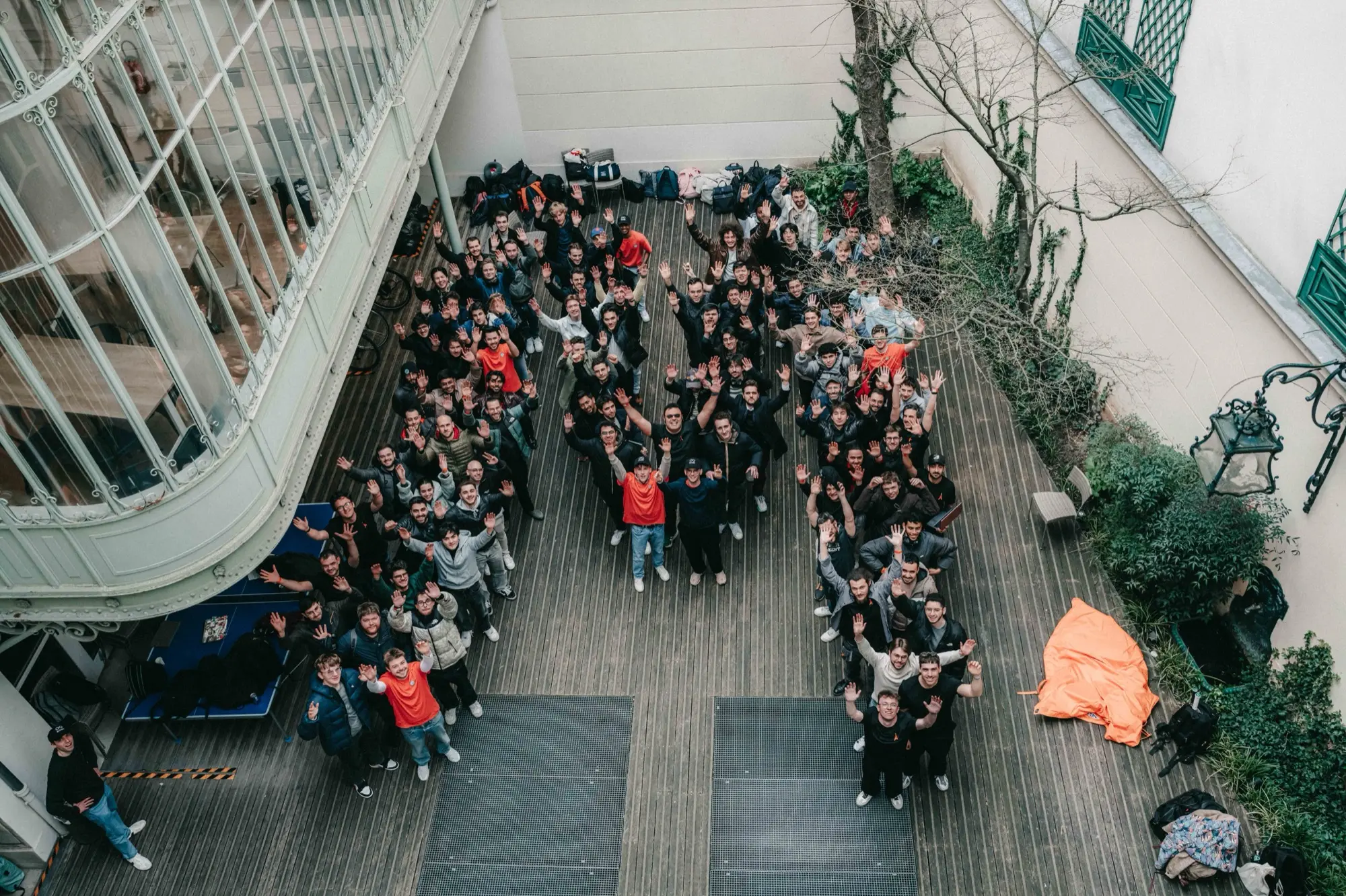 Participants of the Mistral Worldwide Hackathon in Paris, forming the Mistral logo